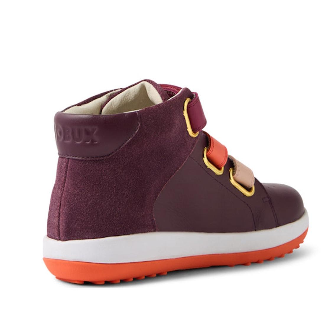 The Bobux KP Kids Plus Juniors Gamepoint Leather Boot in Fig Purple is a maroon high-top kids boot with pink and red velcro straps, yellow strap accents, a white midsole, orange rubber sole, and "BOBUX" embossed on the maroon heel., 9420074815330, 9420074