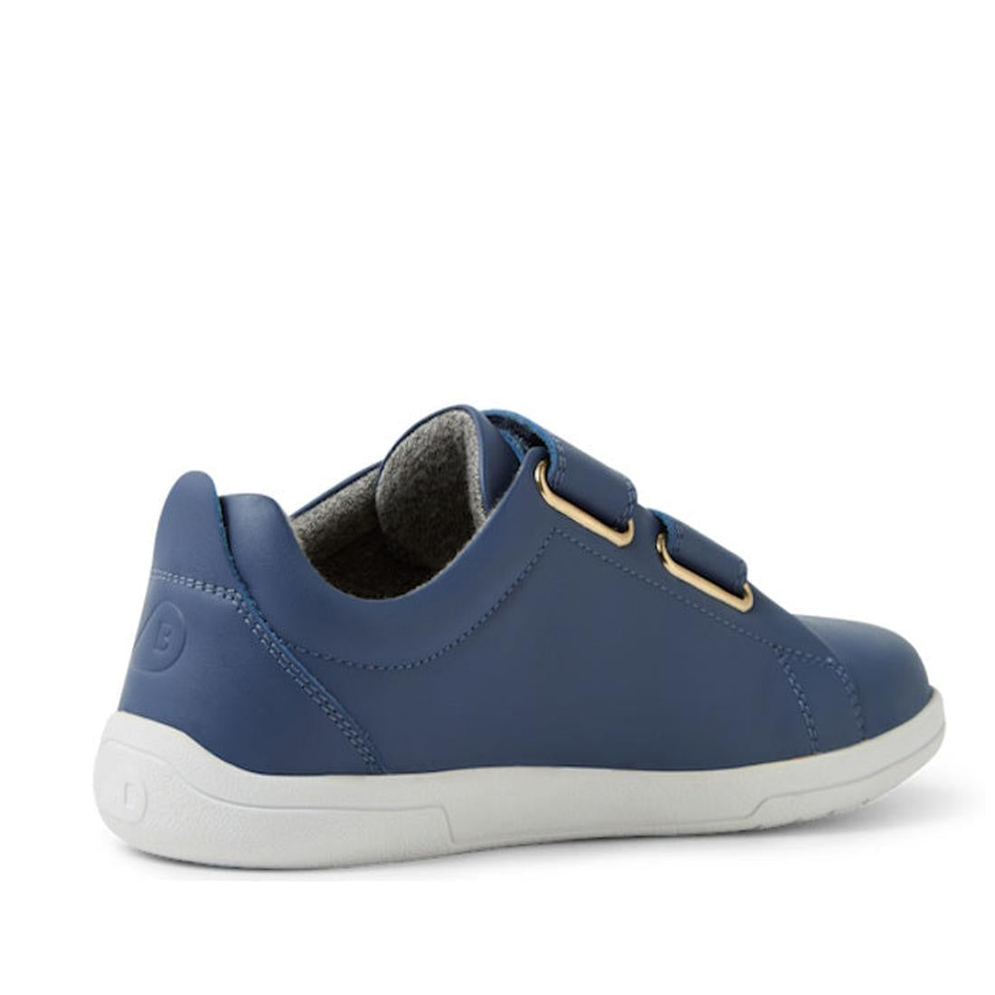The Bobux KP Kids Plus Grass Court II Leather Sneaker in Vintage Indigo Blue features a white sole, two Velcro straps, gray lining, and an embossed heel logo—durable and comfortable for everyday wear, shown from the side., 9420074859440, 9420074859457, 94