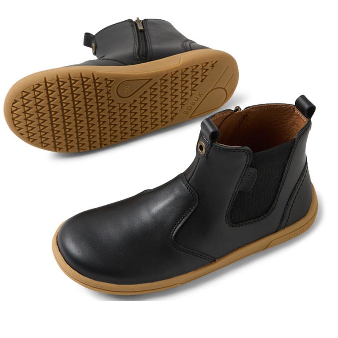 The Bobux KP Kids Plus Jodhpur II Juniors Leather Boot in Black features tan flexible soles, elastic side panels, and a side zipper. One boot stands upright while the other shows its textured sole., 9420074834775, 9420074834812, 9420074834829, 94200748348