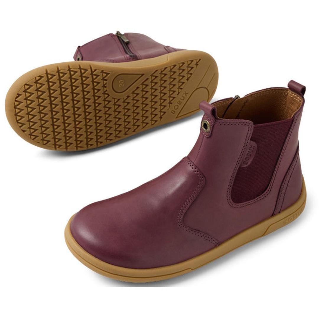 Bobux KP Kids Plus Jodhpur 2 II Juniors Leather Boot Fig Purple: a pair of kids' maroon leather boots with tan rubber soles, flexible sole, side zippers, and elastic panels. One boot stands upright; the other displays its tread pattern., 9420074834980, 94