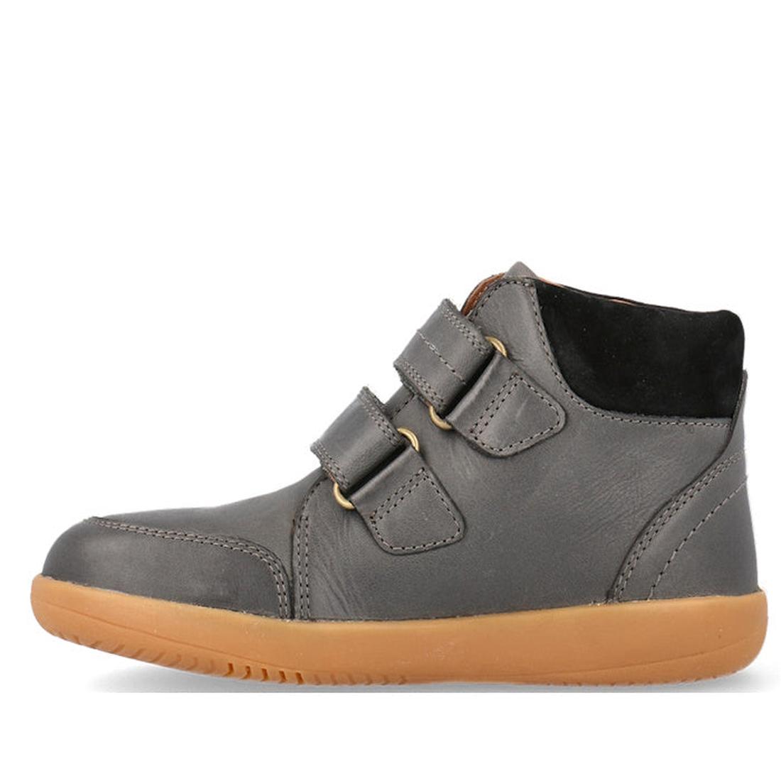 The Bobux Kid+ Timber Boot Charcoal 832924 is a dark gray high-top sneaker with two Velcro straps, tan rubber sole, black padded ankle collar, and visible stitching—perfect as first walkers boots for kids. Shown in side profile on a white background., 942