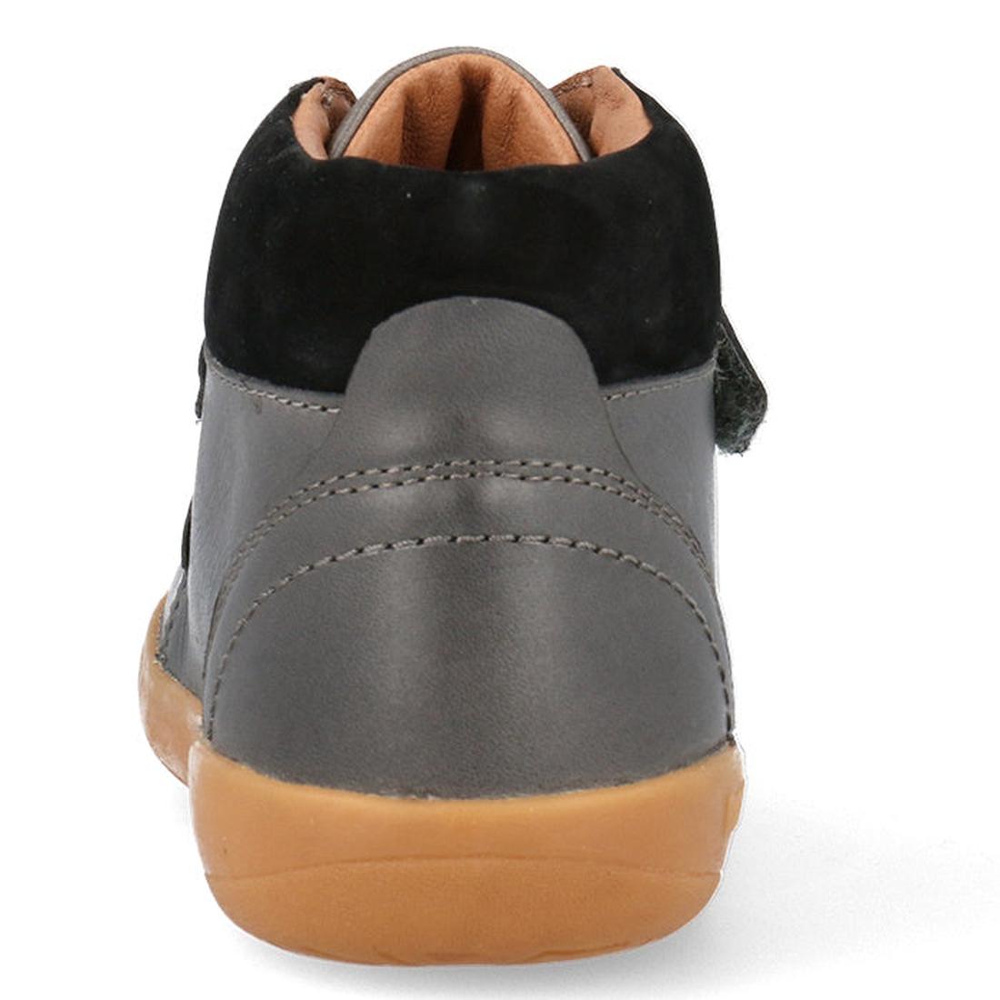 A rear view of the Bobux Kid+ Timber Boot Charcoal 832924, a gray and black children's sneaker featuring a tan rubber sole, visible stitching, and a partially open Velcro strap, similar to classic first walkers boots., 9420075797536, 9420075796652, 942007