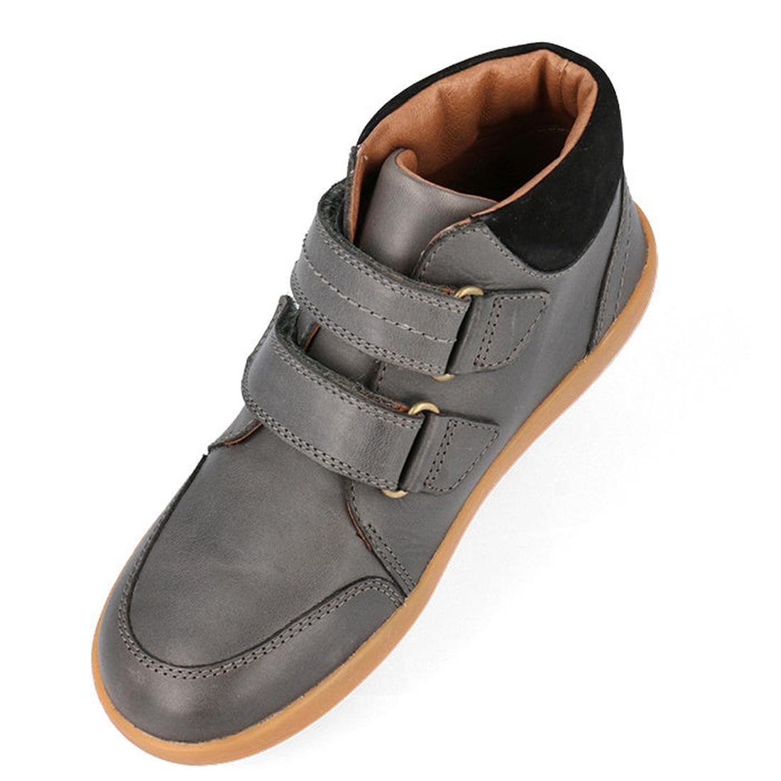 The Bobux Kid+ Timber Boot Charcoal 832924 is a gray high-top unisex leather boot for first walkers, with two Velcro straps, black padded collar, brown lining, and a light brown rubber sole—shown from an angled top view.