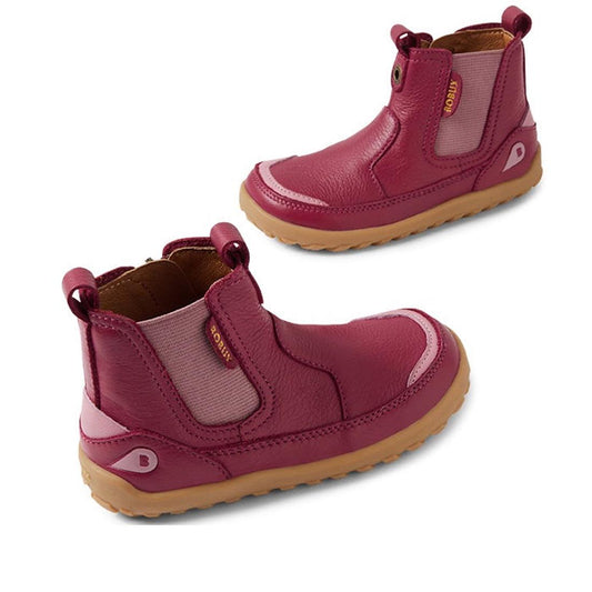 The Bobux KP Kids Plus Trail Leather Boot Juniors in Beaujolais Purple Alpha features a barefoot-shaped toe box, elastic side panels, pull tabs, and light brown rubber soles, shown from side and angled views on a white background.