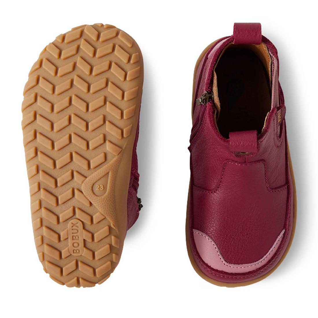 The Bobux KP Kids Plus Trail Leather Boot Juniors in Beaujolias Purple Alpha features tan rubber soles, a zipper closure, barefoot-shaped toe box for natural movement; left shoe shown from the bottom for tread and right highlights the design., 94200685638
