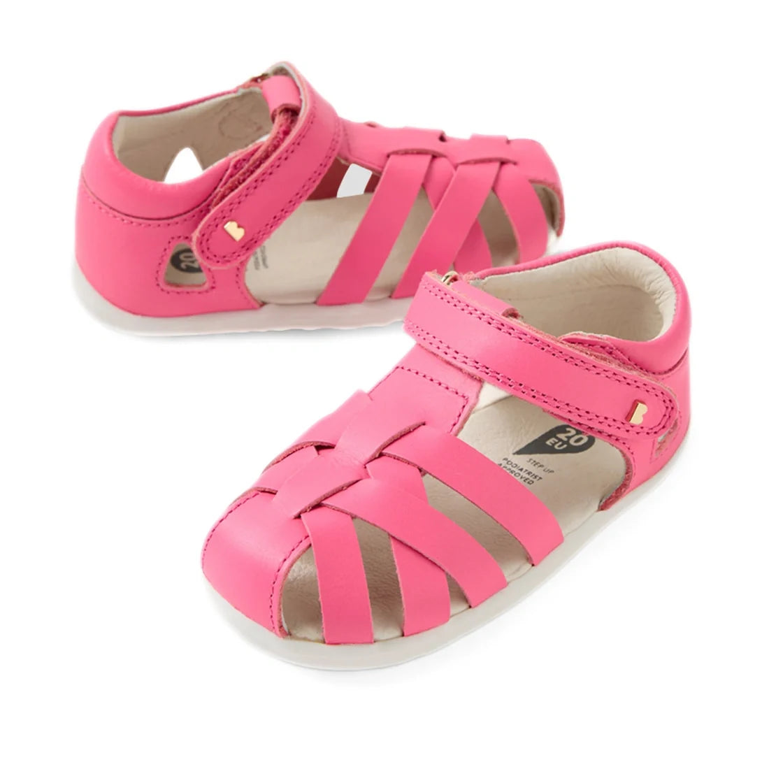 A pair of Bobux Step Up SU Tropicana II Pink Lemonade Closed Toe Sandals for toddlers, featuring closed toes, crisscrossed straps, and Velcro ankle straps, is shown on a white background.