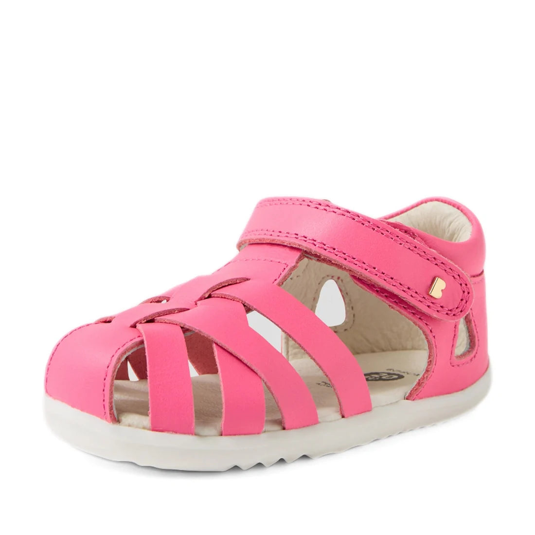 A small, vibrant pink Bobux Step Up SU Tropicana II Pink Lemonade Closed Toe Sandal with a protective closed toe, white sole, and Velcro strap. This sandal features cut-out sides and decorative stitching, designed as stylish closed-toe sandals for young c
