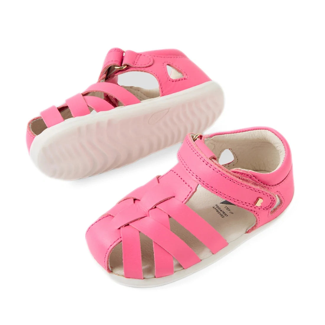 A pair of Bobux Step Up SU Tropicana II Pink Lemonade Closed Toe Sandals, designed for toddlers, featuring a stylish closed heel, woven front straps, a hook-and-loop strap closure, and white soles—perfect closed-toe kids' sandals., 9420074809902, 94200748