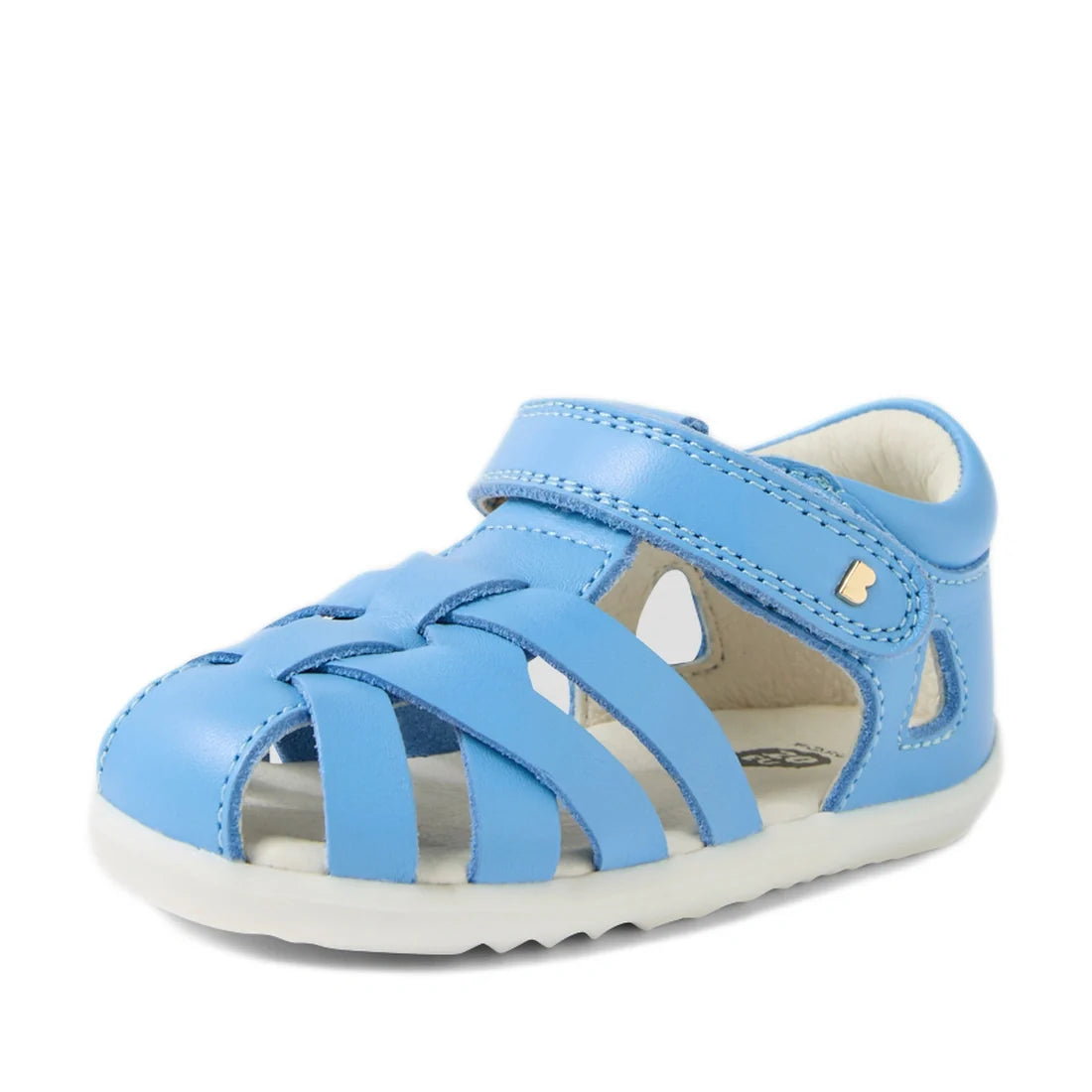 A single Bobux Step Up SU Tropicana II Baltic Sea Blue Closed Toe Sandal designed for toddlers, featuring a light blue leather upper with a closed toe, open sides, Velcro strap, soft white sole, and small decorative cutouts—offering comfort and style for 