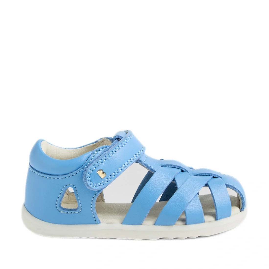 The Bobux Step Up SU Tropicana II Baltic Sea Blue Closed Toe Sandal is a blue toddler sandal inspired by the iconic Bobux Tropicana design. It features a closed heel, open toe, and crisscross straps, along with a Velcro strap and a small heart detail near