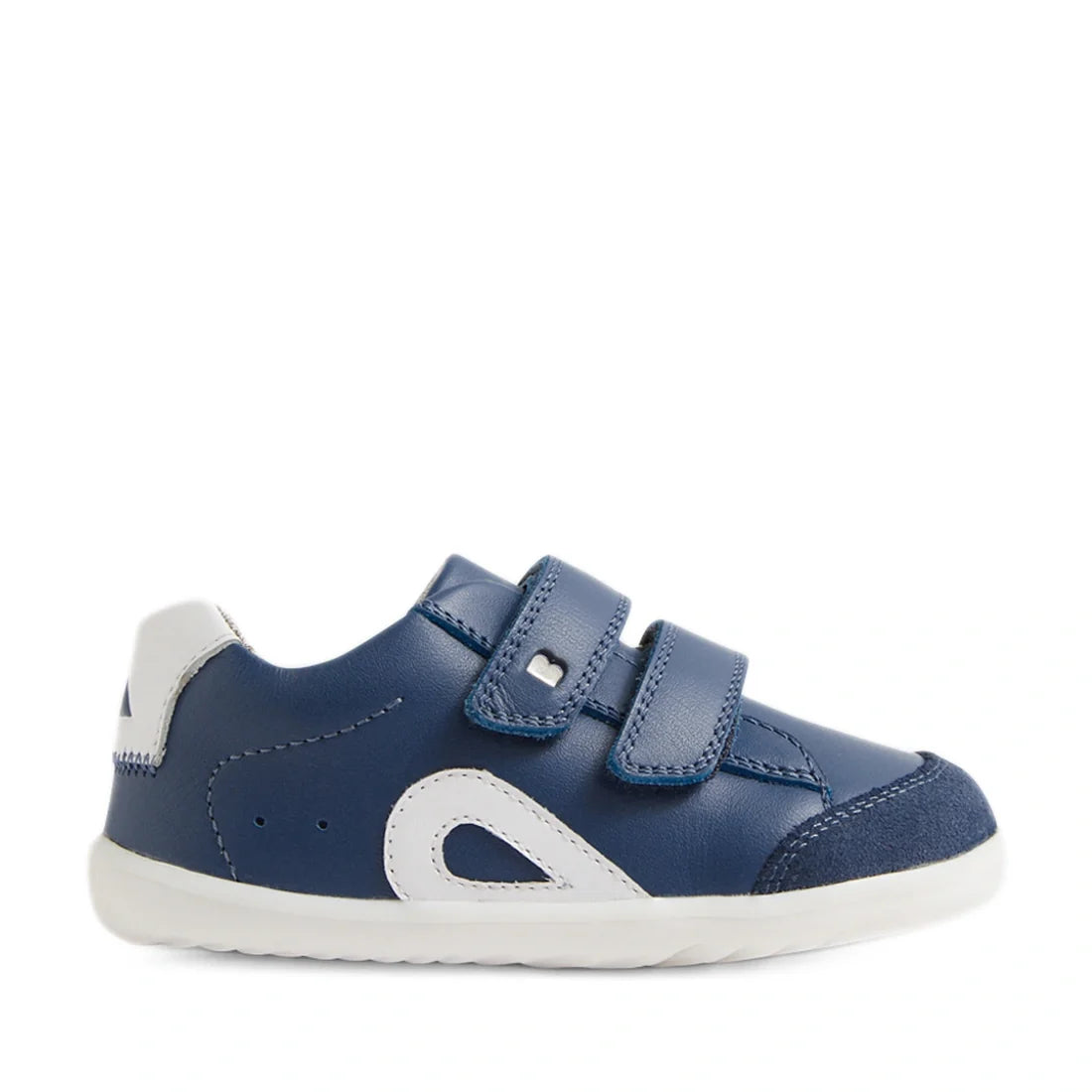 The Bobux SU Step Up Blaze Leather Toddlers Sneaker in Vintage Indigo is a blue and white first walking shoe for toddlers, featuring two velcro straps, white accents, a white rubber sole, and a rounded toe. It is shown in profile facing right on a plain w