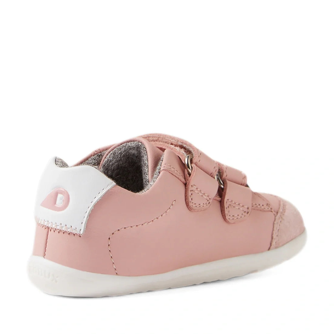 Introducing the Bobux SU Step Up Blaze Leather Toddlers Sneaker in Ballet Pink—a stylish first walking shoe for children, shown from a rear side angle on a white background. This sneaker features two velcro straps, a crisp white heel accent, and a soft wh