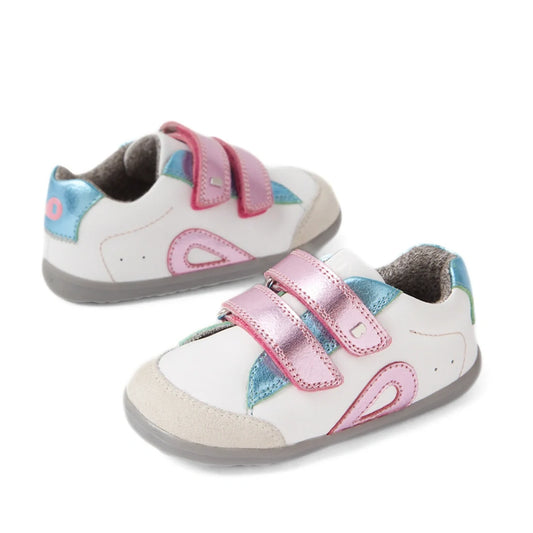The Bobux SU Step Up Blaze Leather Toddlers Sneaker in White Pink features white leather with blue and pink accents, shiny pink velcro straps, and grey soles—making them the perfect first walking shoes for your little one.