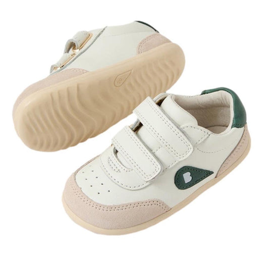 The Bobux Step Up SU Champ II Sneaker in Chalk White Rainforest Green features beige soles, white uppers, light pink suede accents, green heel detail, heart-shaped green side patches, and two hook-and-loop straps for easy fastening.