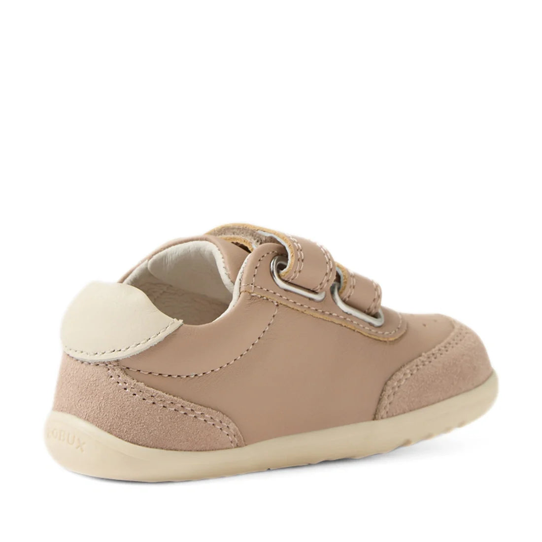 The Bobux Step Up SU Champ Sneaker First Walker in Warm Taupe features a tan design with a hook and loop strap, suede accents, and a white heel patch, shown from the back and side on a white background—perfect first walker sneakers designed for support an