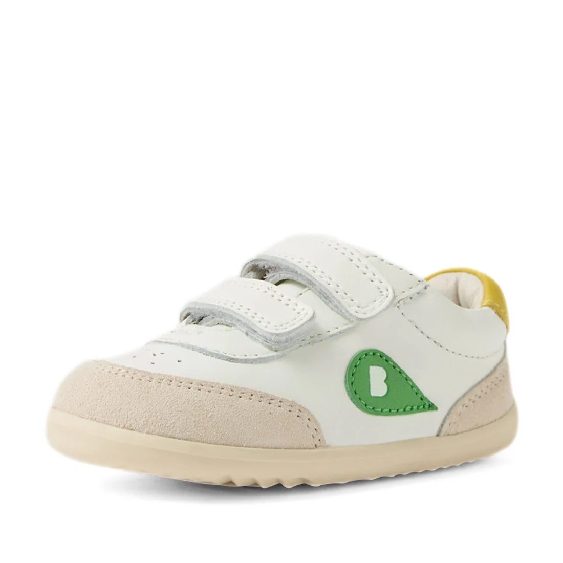 The Bobux Step Up SU Champ Sneaker First Walker in White Green is a small toddler shoe featuring two hook-and-loop straps, a green teardrop-shaped B patch on the side, and a yellow heel accent—offering stylish and comfortable first walkers for little ones