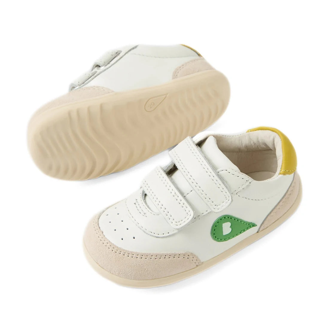 The Bobux Step Up SU Champ Sneaker First Walker in White Green features white leather with beige soles, light tan toe caps, green heart details on the side, yellow heel accents, and two hook-and-loop straps—making these adorable kids’ sneakers perfect for
