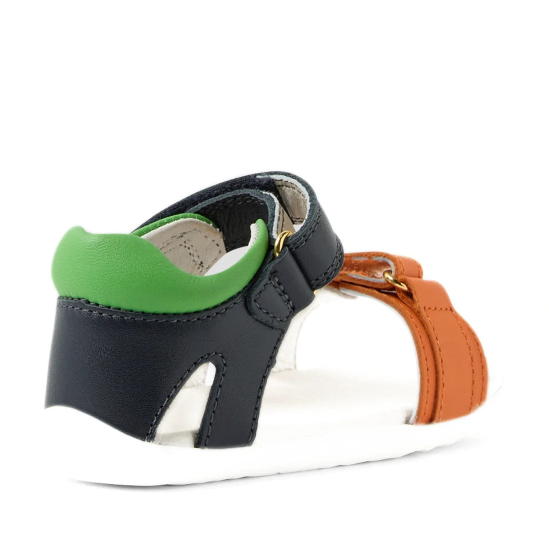 A child’s sandal—the Bobux SU Step Up Dune First Walker Open Toe Sandal in Navy—features a green heel, black sides, orange front straps, and a white sole. Viewed from a back side angle, these adventure-ready sandals are perfect for little explorers., 9420