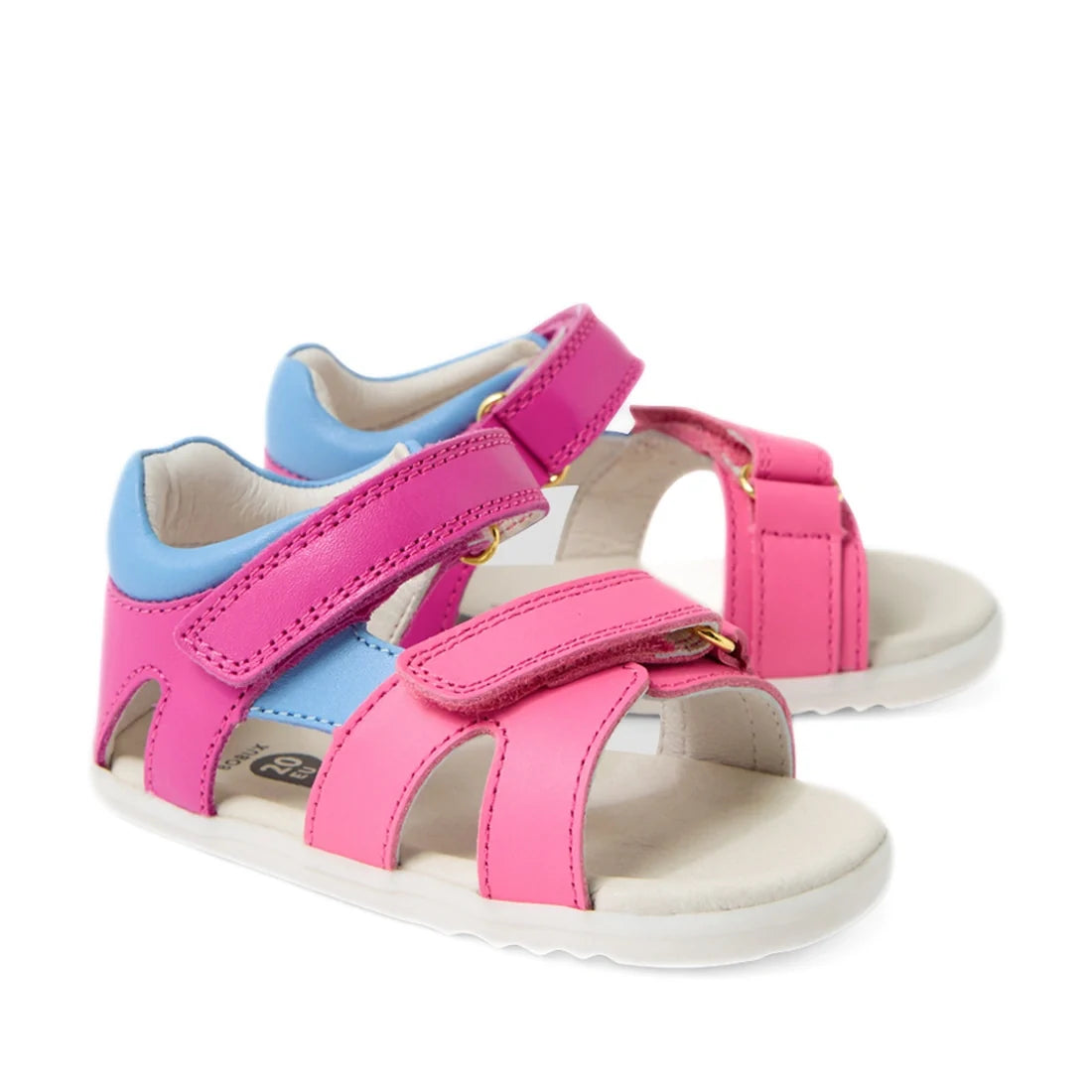 A pair of Bobux SU Step Up Dune First Walker Open Toe Sandal Rose Bright Pink sandals featuring bright pink adjustable straps, soft white soles, and Velcro closures—these children’s sandals combine playful style with all-day comfort.