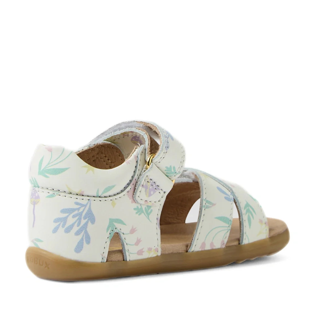 The Bobux Step Up Flora First Walker Sandal in White Floral features a pale floral print, an open-toe design, a tan sole, and a side buckle. Seen from the back and side to showcase the heel and straps, these leather sandals offer both style and support—pe