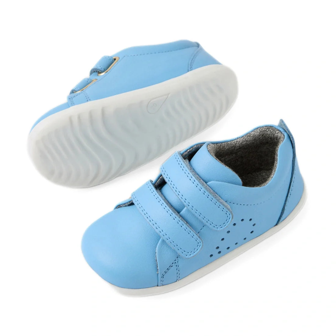 A pair of Bobux Step Up Grass Court Trainer Baltic Sea Blue toddler shoes featuring white soles, two velcro straps, and subtle perforated side details—premium leather sneakers especially designed for first walkers., 9420074806604, 9420074806611, 942007480