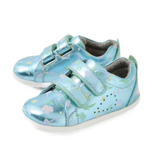 Bobux Step Up Grass Court Trainer Jelly Mint Metallic Blue shoes, featuring shiny light blue hues with floral patterns and two velcro straps, placed side by side on a white background.
