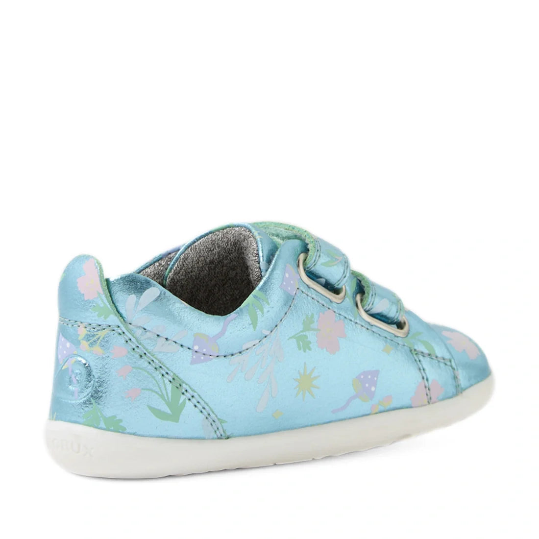 The Bobux Step Up Grass Court Trainer Jelly Mint Metallic Blue sneaker, featuring a light blue hue, pastel floral accents, dual velcro straps, and a white sole, is shown from a rear side angle—making it an ideal and stylish first walker shoe for children.
