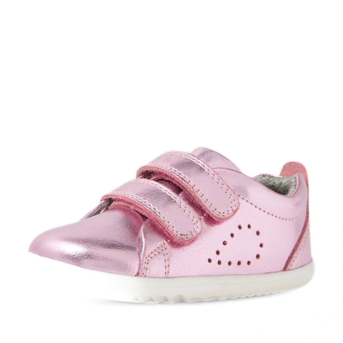 The Bobux Step Up Grass Court Trainer Pink Metallic is a shiny pink leather sneaker for kids, featuring two Velcro straps, a white sole, and small decorative perforations on the side forming a heart shape—perfect for first walkers exploring in style., 942