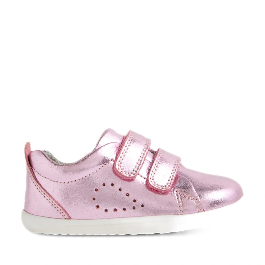 The Bobux Step Up Grass Court Trainer Pink Metallic is a shiny pink toddler shoe inspired by the classic Grass Court design, featuring two hook-and-loop straps, small decorative side perforations, and a white rubber sole—perfect first walkers for little o