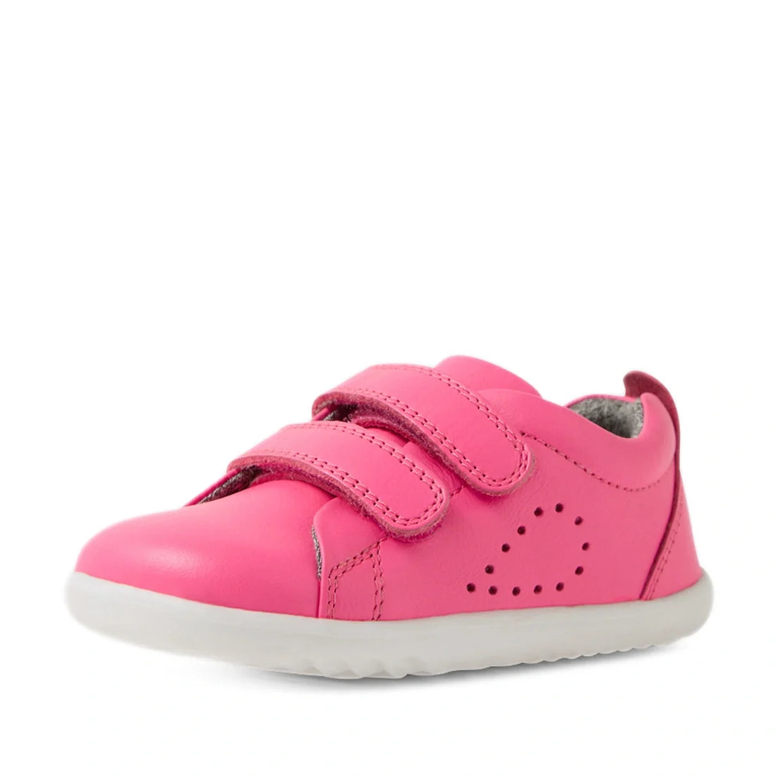 The Bobux Step Up Grass Court Trainer in Pink Lemonade is a single pink leather kids sneaker featuring two velcro straps, a perforated side design, white sole, and gray inner lining, shown on a white background—perfect as wide fit toddler shoes or stylish