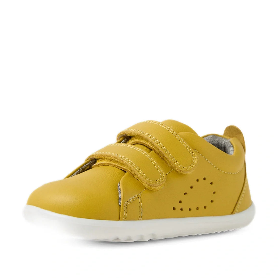 A small yellow Bobux Iwalk Toddlers Grass Court Mango Mint Leather Trainer with two Velcro straps, a white sole, and decorative perforations on the side is shown against a white background., 9420074807083, 9420074807090, 9420074807106, 9420074807113, 9420