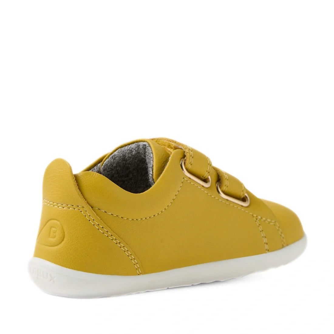 A yellow Bobux Step Up Grass Court Trainer in Mango Mint Yellow for kids, featuring two velcro straps and a white sole, shown from the back and side against a white background. Ideal as first walker sneakers, these stylish shoes provide comfort and suppor
