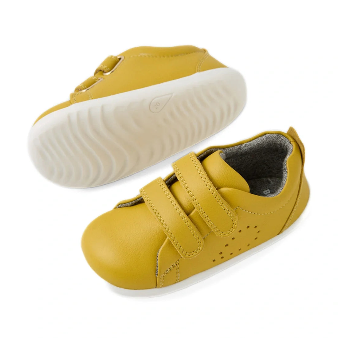 A pair of Bobux Iwalk Toddlers Grass Court Mango Mint Leather Trainer Yellow sneakers, featuring white rubber soles and two Velcro straps, is displayed from side and bottom views against a white background. Inspired by the classic Grass Court design, thes