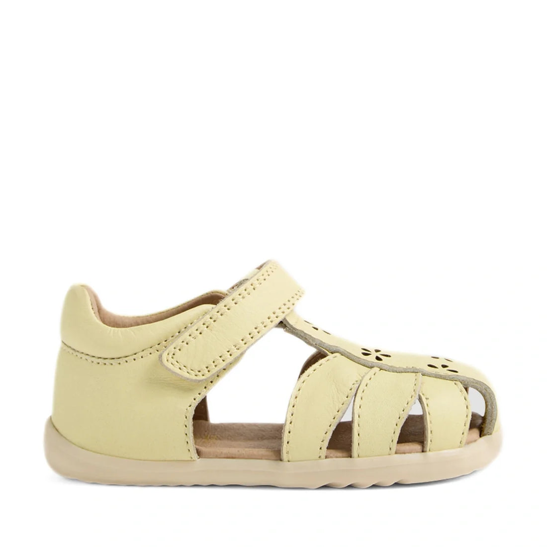The Bobux Step Up Grass Holly First Walker Closed Toe Sandal in Wax Yellow is a light yellow leather sandal for toddlers, featuring a closed heel, open toe, Velcro strap, and stylish cutout details on top—shown in profile view against a white background f