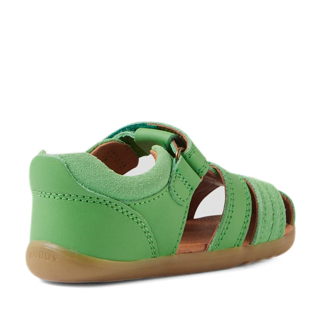 A rear side view of the Bobux Step Up Sandal Roam Closed Toe Sandals in Retro Green for children, featuring green leather with a closed toe and heel, open sides, an adjustable strap, brown sole, and visible stitching—ideal as first walker shoes., 94200748