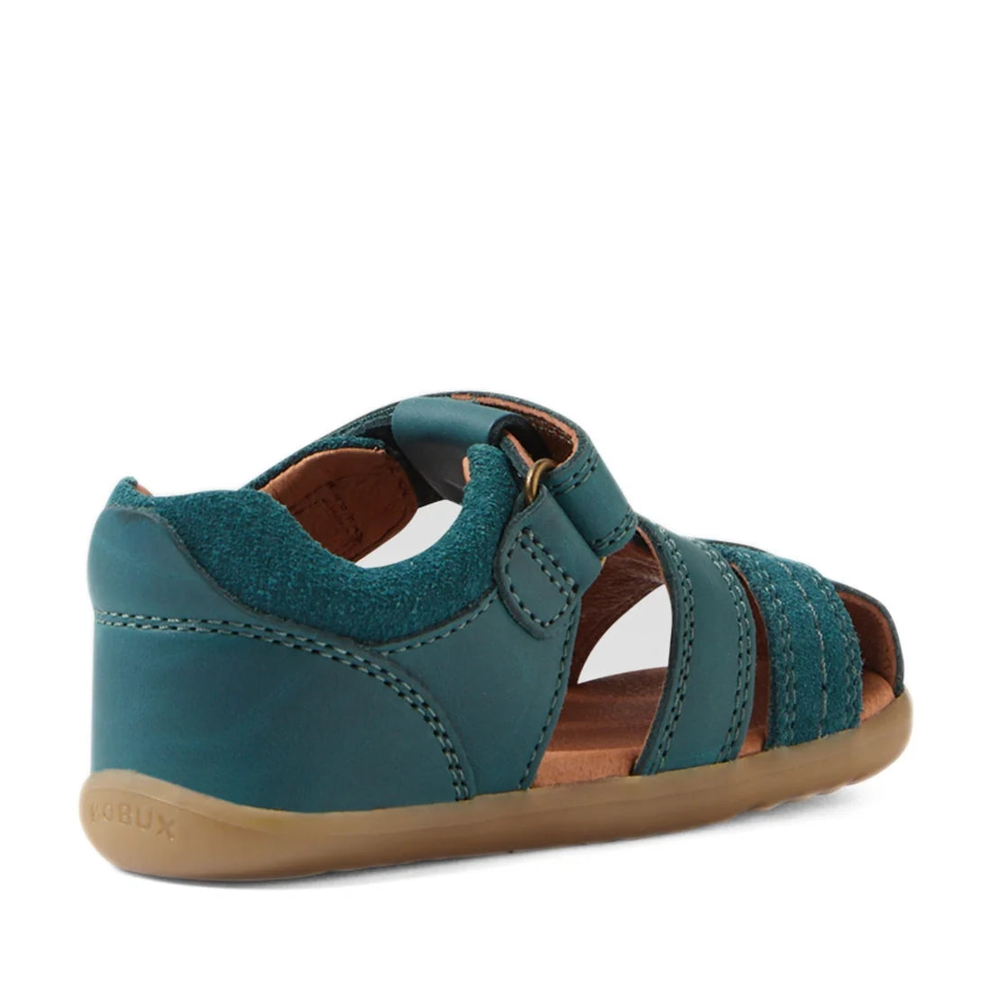 A Mediterranean green toddler sandal inspired by the Bobux Step Up Sandal Roam Closed Toe Sandals features a closed heel, open toe, adjustable strap, and flexible tan sole. Crafted in the style of classic leather sandals and viewed from the side and sligh