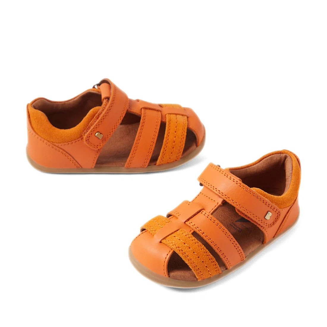Two small Bobux Step Up Sandal Roam Closed Toe Sandals in Orange Peel, featuring Velcro straps, closed toes, and rubber soles, are displayed on a white background., 9420074807250, 9420074807267, 9420074807274