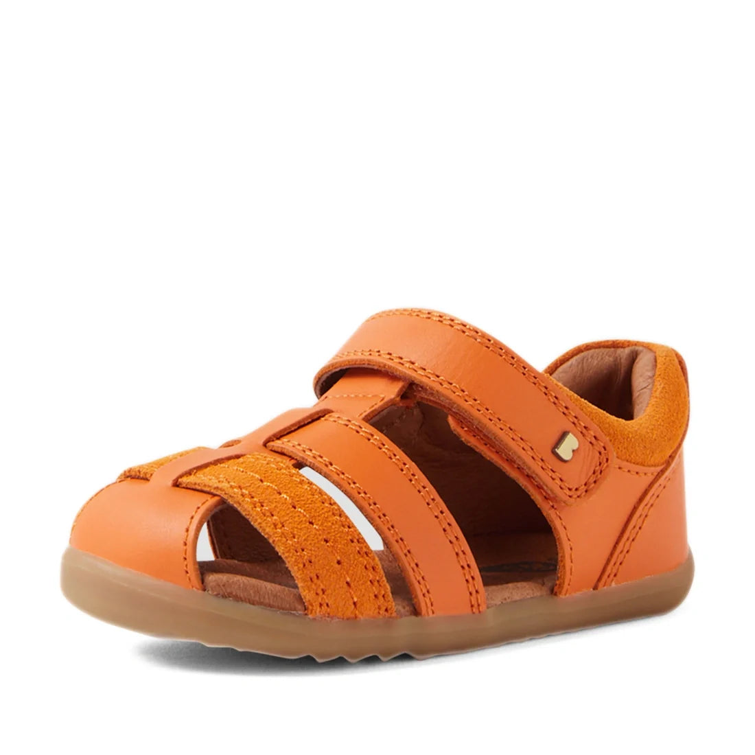 The Bobux Step Up Sandal Roam Closed Toe Sandals in Orange Peel are toddler leather sandals featuring multiple straps, a Velcro closure, suede accents, and a brown rubber sole. These stylish orange sandals are displayed at an angle on a white background.,
