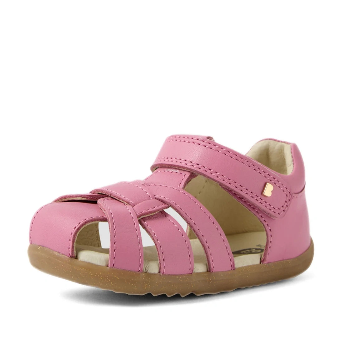 The Bobux Step Up Sandal Skip Twist Closed Toe Sandals in Cashmere Rose Pink are toddler sandals with crisscross straps, a Velcro closure, and a light brown rubber sole—ideal as first walking leather sandals—shown on a white background., 9420074850096, 94