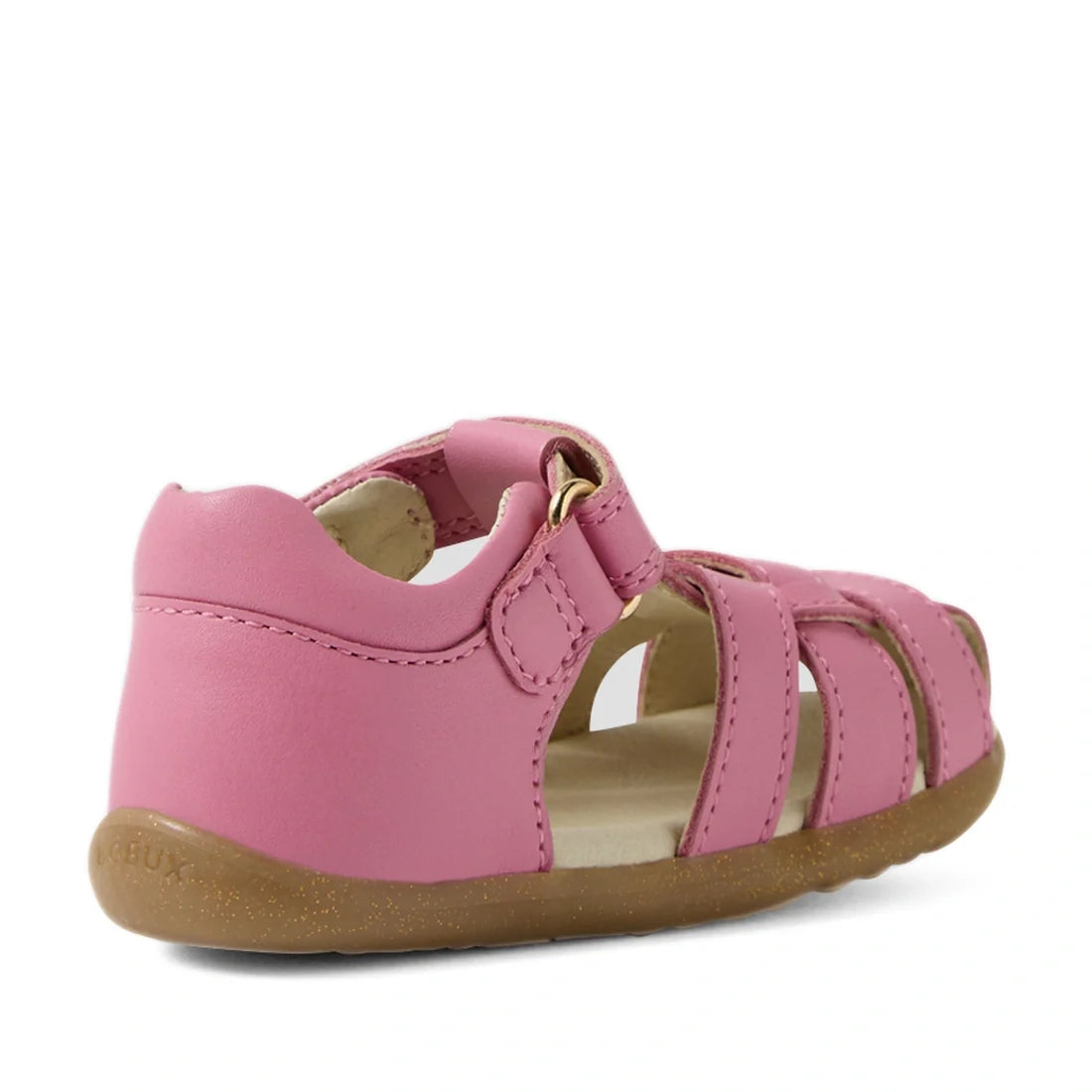 The Bobux Step Up Sandal Skip Twist Closed Toe Sandals in Cashmere Rose Pink are toddler sandals featuring a closed heel, open toe, hook-and-loop strap, and brown rubber sole. Designed as ideal first walking leather sandals, this style is displayed from a