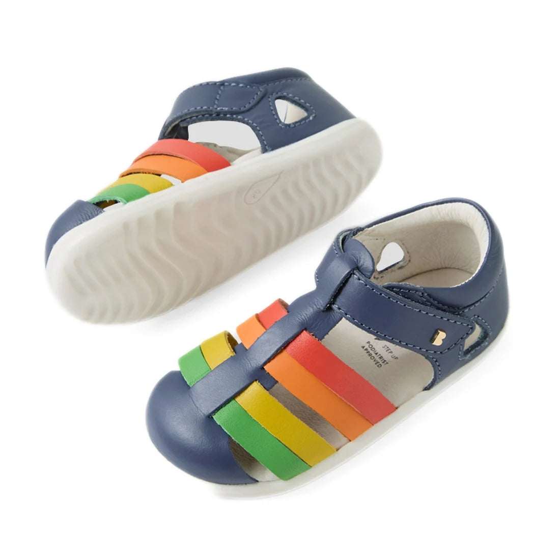 Two pairs of the Bobux Step Up SU Toddlers Tidal Vintage Indigo Blue Closed Toe Sandal, featuring water-friendly leather in classic blue with white soles and colorful green, yellow, orange, and red straps across the tops—perfect for active little feet., 9