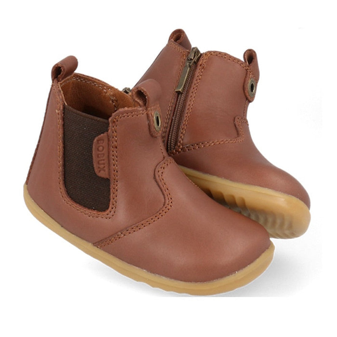 The Bobux Step Up Jodphur Boot Toffee 721926A features brown leather, elastic side panels, side zippers, pull tabs, and light brown rubber soles—a perfect unisex first walker ankle boot for toddlers shown against a white background.