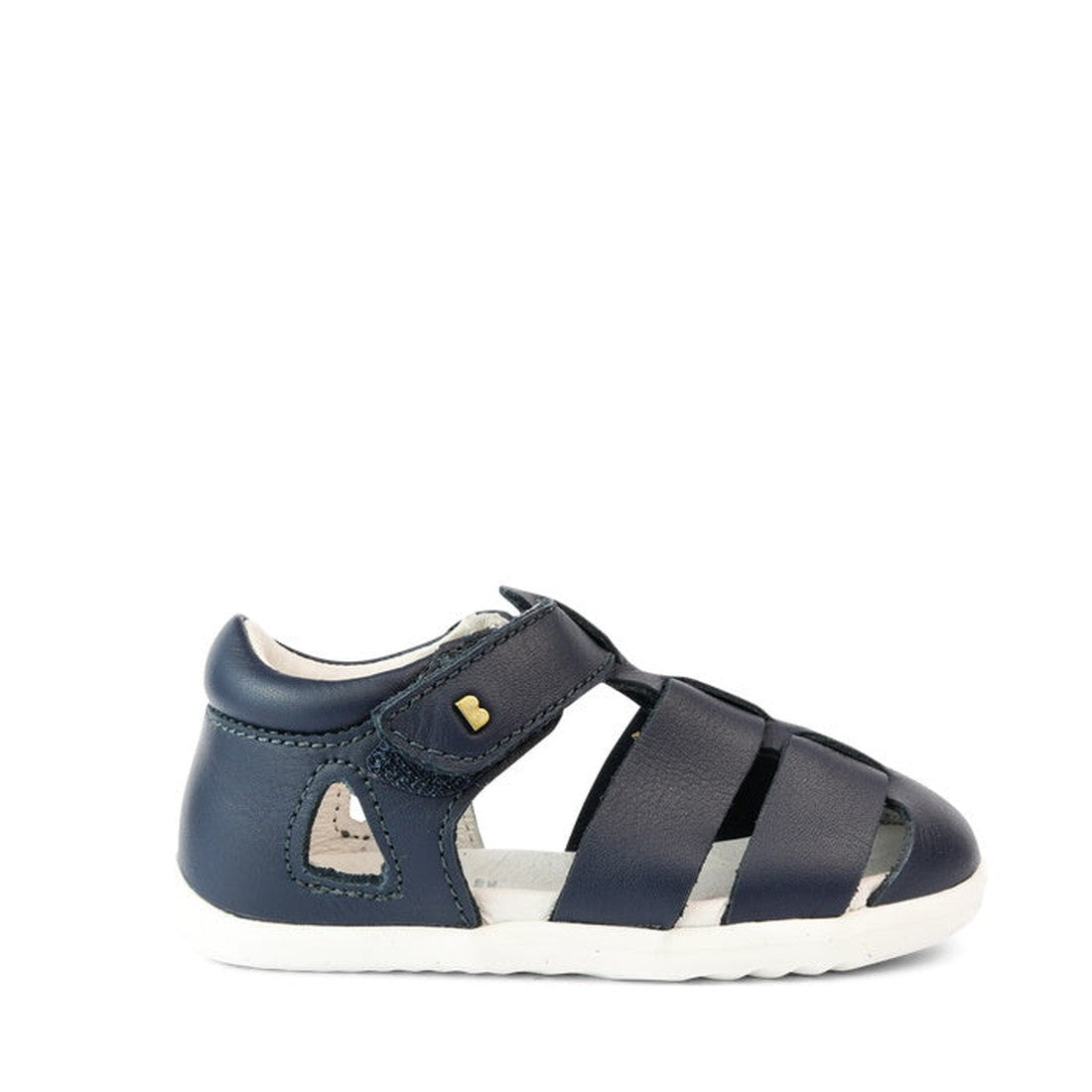 The Bobux Step Up US Tidal Navy Closed Toe Sandal 732503 is a navy toddler sandal with closed toe and heel, open sides, white sole, velcro strap, and a gold heart detail—ideal as first walker shoes., 9420068502574, 9420068502581, 9420068502598, 9420068502