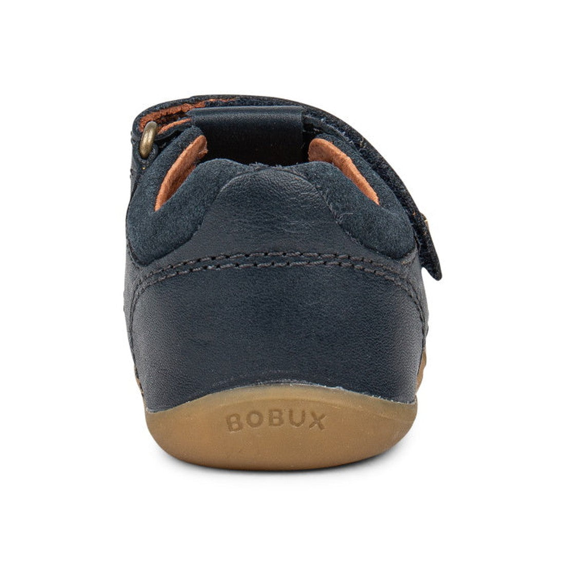 A rear view of the Bobux Step Up Sandal Roam 729201A Navy Closed Toe shows a navy blue leather children's shoe with a tan rubber sole and BOBUX embossed on the heel—ideal first walking sandals with a soft, flexible leather upper for little explorers., 942