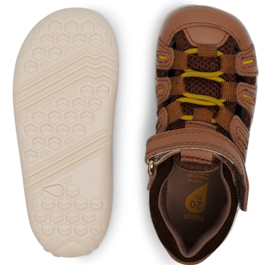 The Bobux Step Up Summit Caramel Toffee Sandal 731609 for children is shown in brown and yellow leather, featuring a water-friendly, closed-toe design with a hook-and-loop strap and a hexagonal-patterned sole—ideal first walkers or action sandals., 942007