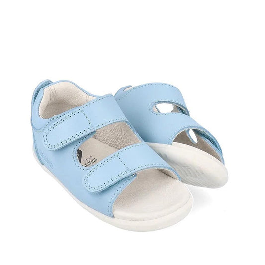 The Bobux Step Up - Topia Sandal First Walking in Glacial Blue (751303) features two velcro straps and white soles, offering supportive, stylish comfort for toddlers’ first steps; shown here against a white background.