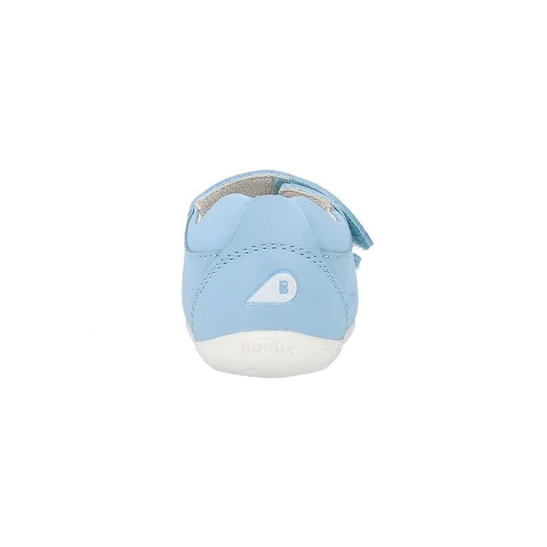 The Bobux Step Up - Topia Sandal First Walking Glacial Blue 751303 is a light blue leather baby sandal with a white sole, small B logo, blue side strap, and is shown from the back on a white background., 39287, 9420075763760, 9420075763678, 9420075763777