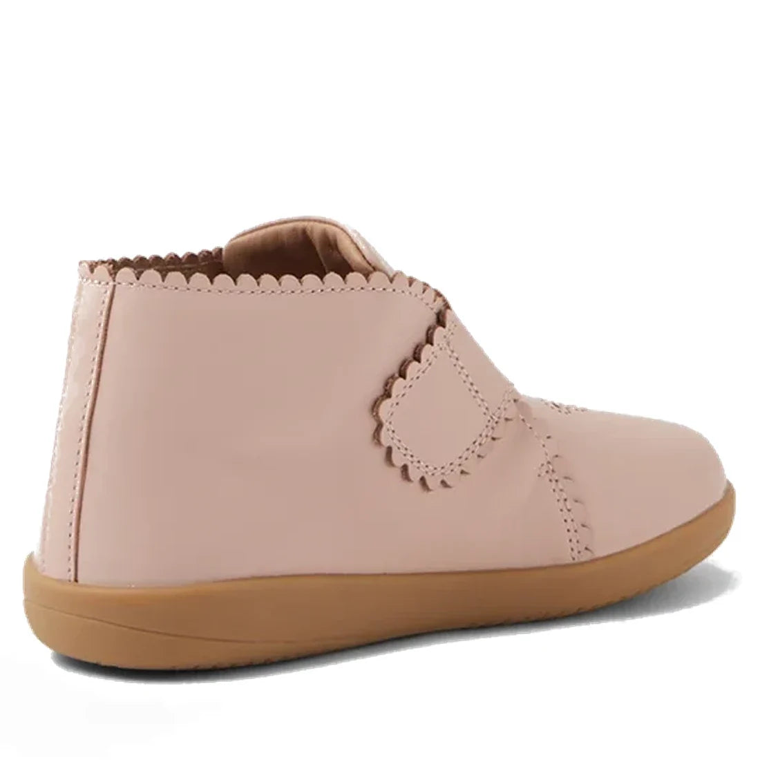 The Bobux Step Up Willow First Walker Boot in Cameo Rose Pink features light pink leather, a tan rubber sole, scalloped edges, and an adjustable Velcro strap—ideal for toddlers taking their first steps., 51154, 9420068544833, 9420068544840, 9420068544857,