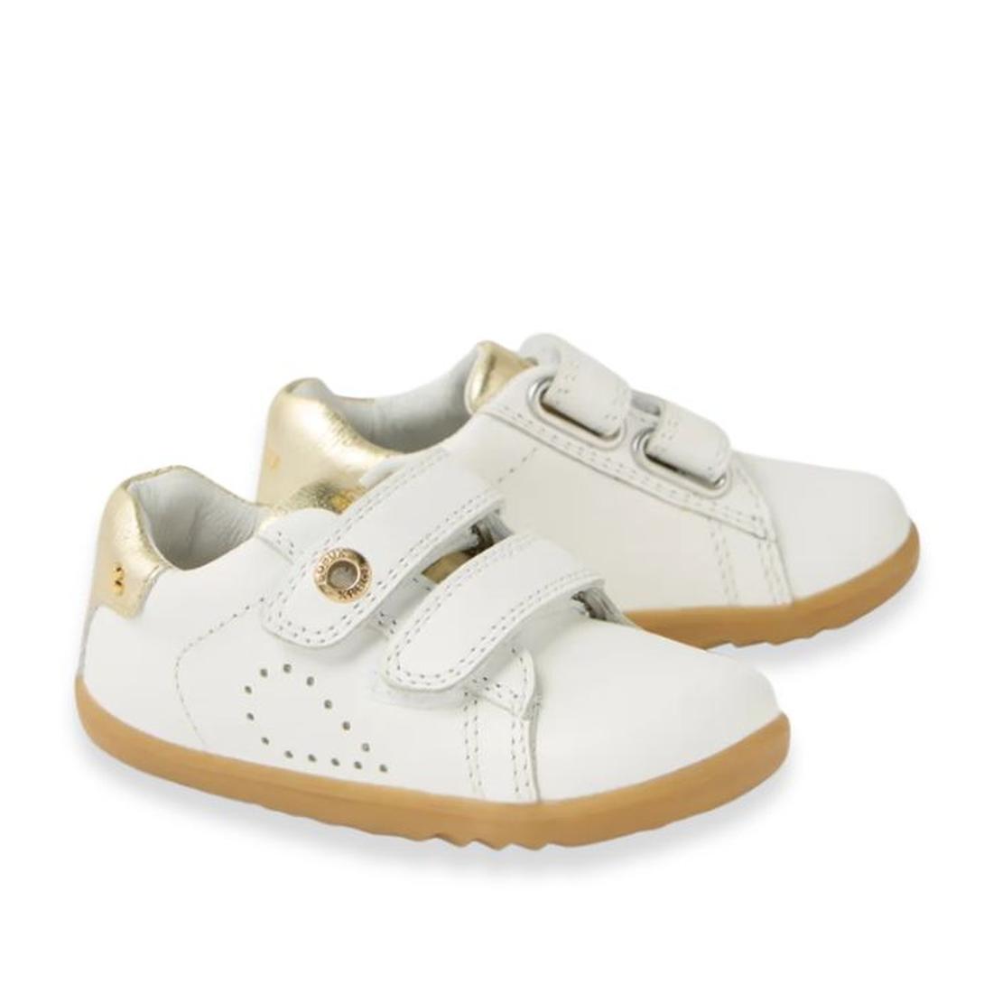 The Bobux SU Step Up Maverick Leather Toddlers Sneaker in White Gold features white leather, tan rubber soles, gold accents on the heel, and two adjustable hook-and-loop straps for a secure fit., 9420074836748, 9420074836755, 9420074836762