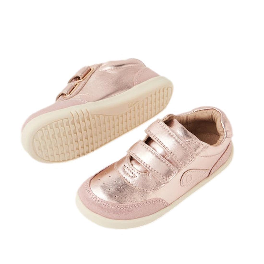 Two shiny rose gold Bobux Toddlers IWalk IW Champ Sneakers (650510) with velcro straps and cream soles, shown side and bottom on a white background—perfect unisex everyday shoes for kids.